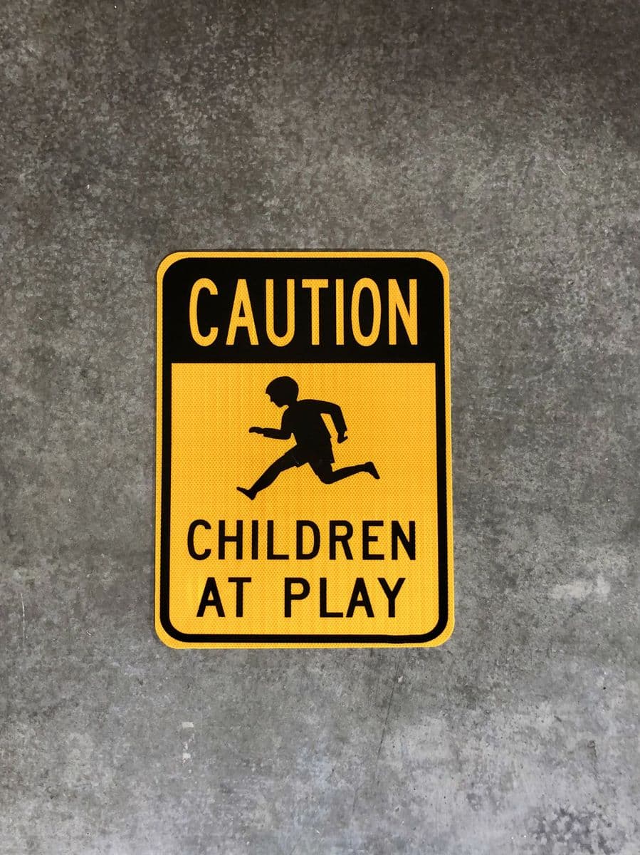 Yellow “Caution — Children at Play” custom road sign