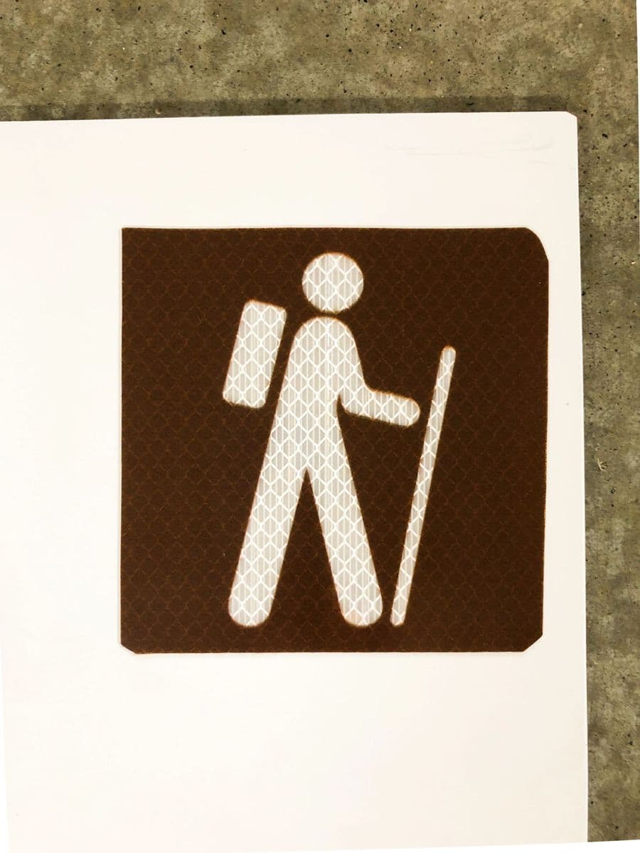 Brown recreational guide sign with hiker symbol