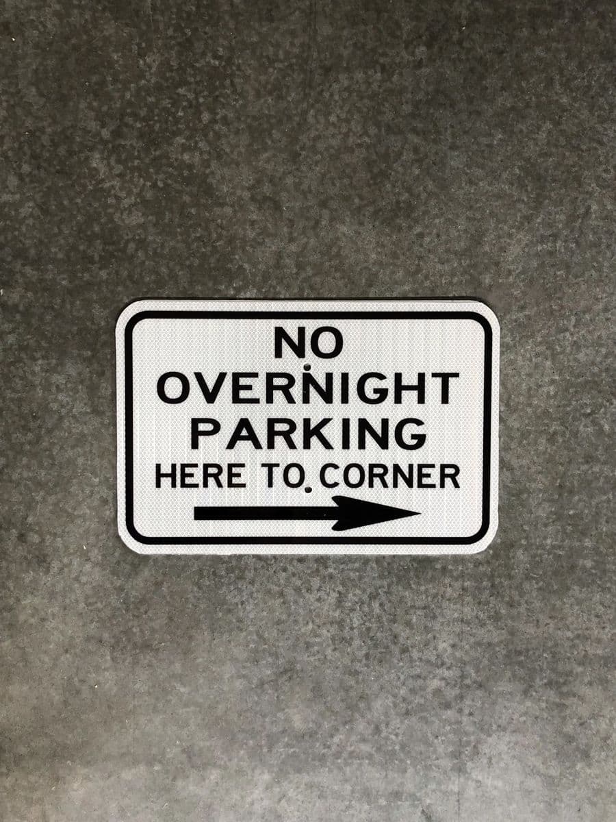 “No Overnight Parking Here to Corner” sign with arrow