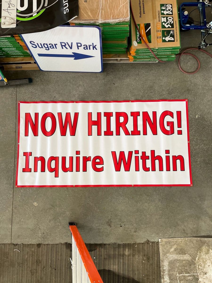 “Now Hiring — Inquire Within” banner printed for a local business