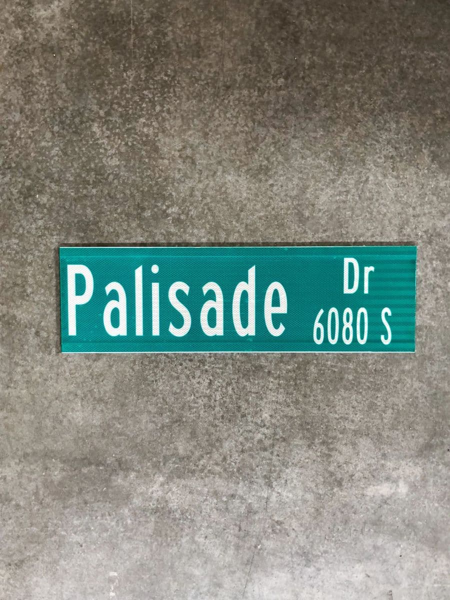 Custom green “Palisade Dr” street name blade printed by the ITS sign shop