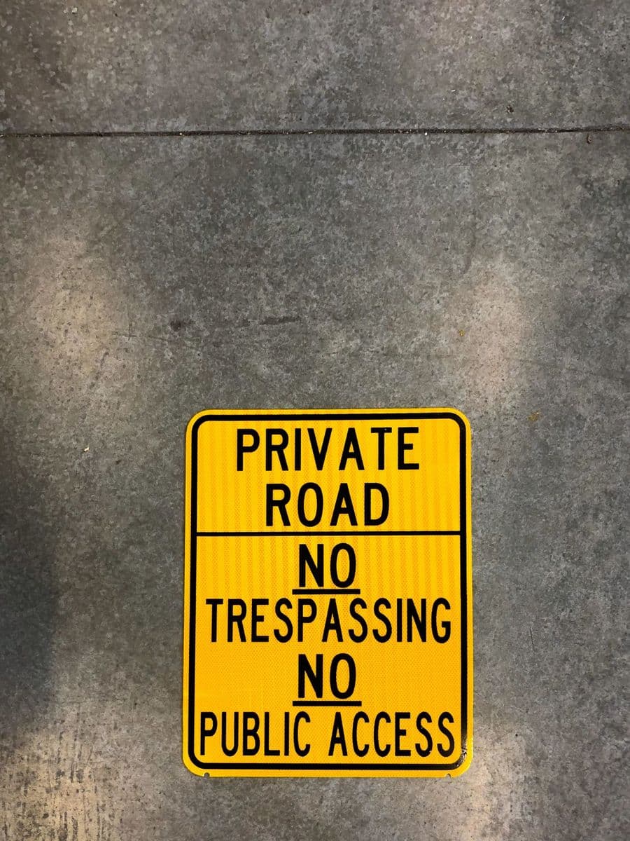 Yellow “Private Road — No Trespassing, No Public Access” sign