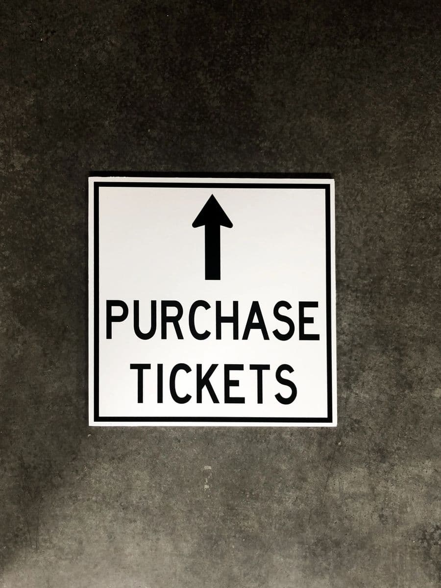 “Purchase Tickets” event wayfinding sign with arrow