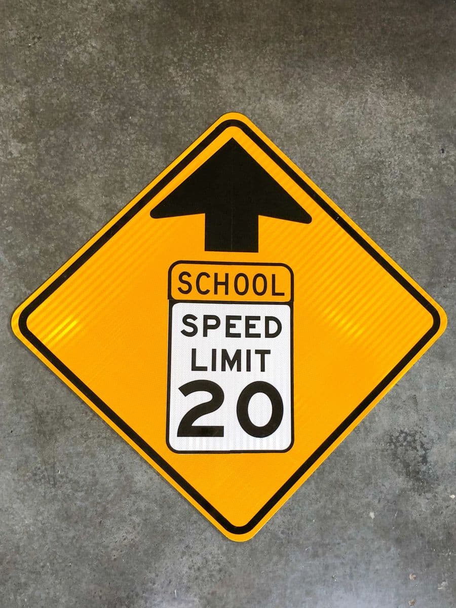 School Speed Limit 20 warning sign with directional arrow